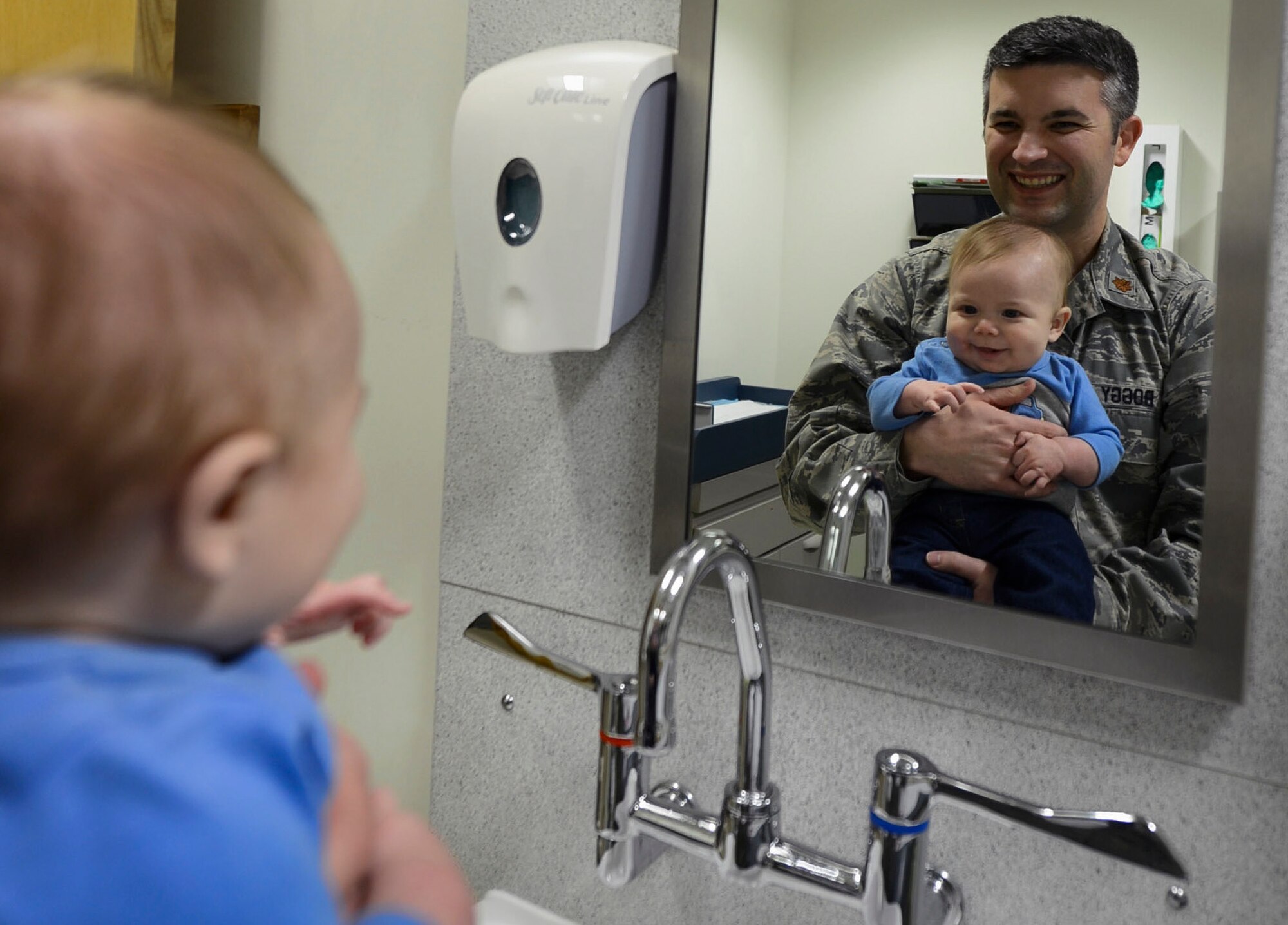 Maj. Marc Boggy, 48th Medical Operations Squadron pediatrician, observes James Bondeson, 4-month-old military dependent, during a well-child visit at the pediatric clinic on Royal Air Force Lakenheath, England, Jan.  22, 2015. The main focus for the Airmen of the pediatric clinic is to successfully monitor the growth of their patients’ first year of life. (U.S. Air Force photo by Airmen 1st Class Dawn M. Weber/Released)