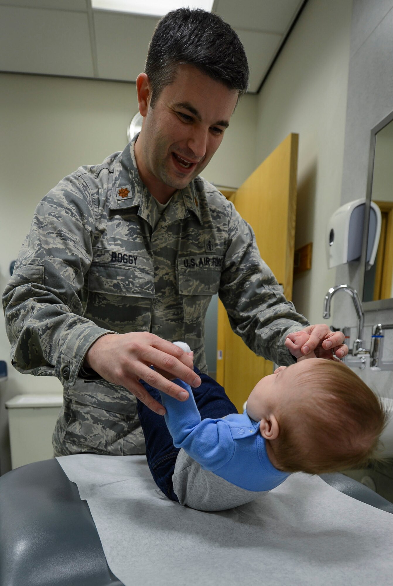 Maj. Marc Boggy, 48th Medical Operations Squadron pediatrician, examines James Bondeson, 4-month-old military dependent, during a well-child visit at the pediatric clinic on Royal Air Force Lakenheath, England, Jan.  22, 2015. Well-child visits ensure proper growth of children during their first year of life. (U.S. Air Force photo by Airmen 1st Class Dawn M. Weber/Released)