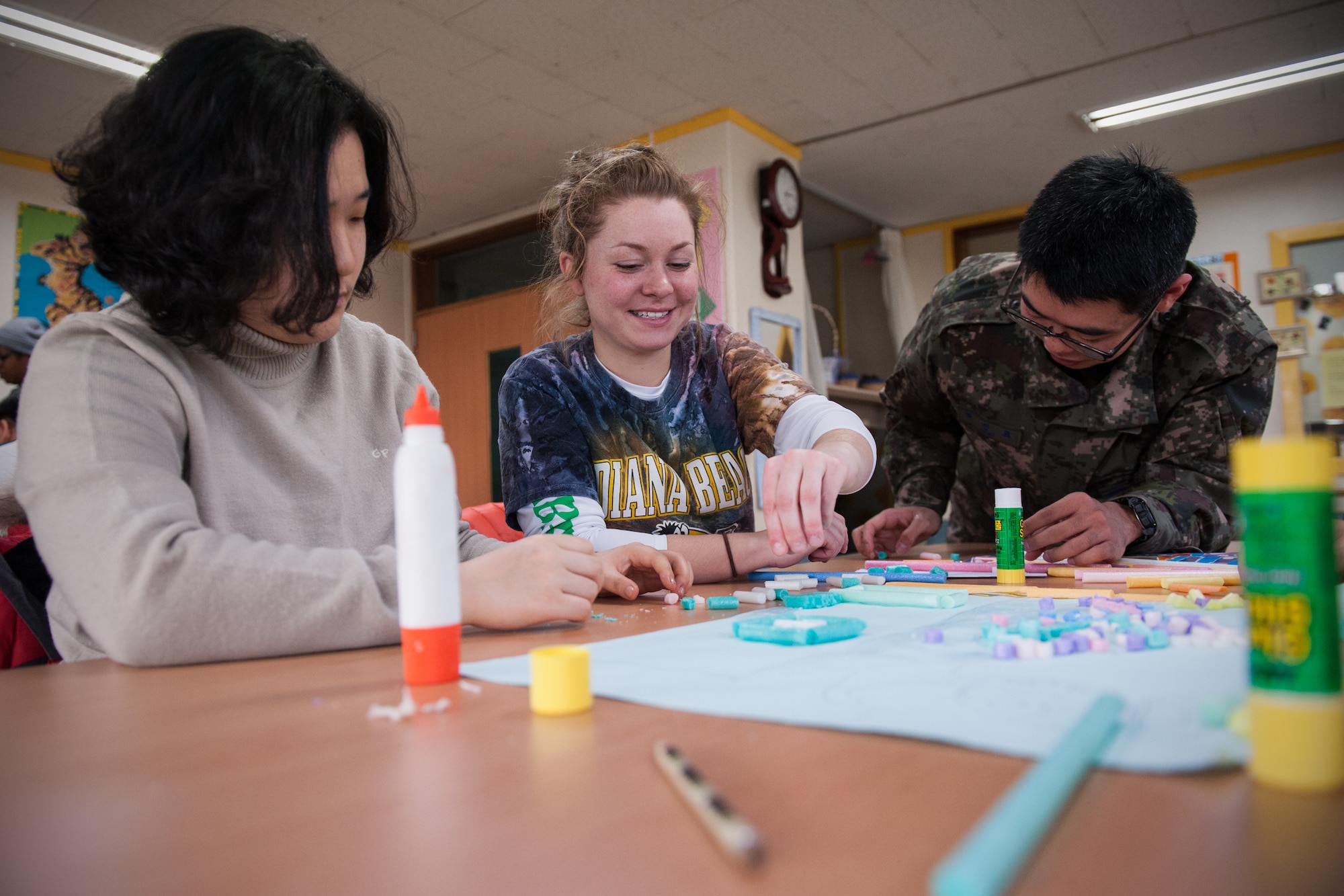 Members of both the Wolf Pack and Republic of Korea Air Force create art at the Gunsan City Rehabilitation Center in Gunsan City, Republic of Korea, Jan. 22, 2015. ROKAF and U.S. Air Force members volunteered for the day at the rehabilitation center to help clean the facility and interact with the residents. (U.S. Air Force photo by Senior Airman Taylor Curry/Released) 