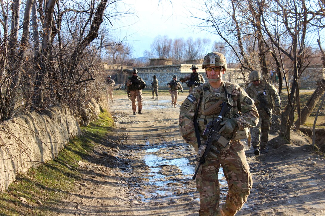 U.S. Army Sgt. 1st Class Jason Hickman, foreground, leads a patrol with Czech and Afghan soldiers through a village in Parwan province, Afghanistan, Jan. 27, 2015. Hickman is assigned to the 3rd Infantry Division's 2nd Squadron, 3rd Cavalry Regiment. 