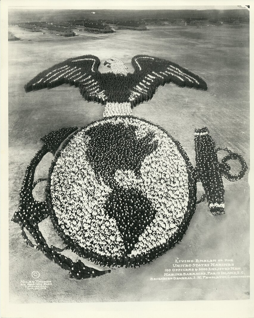 In 1919 the Depot’s permanent personnel and recruits took the time to create what was then considered to be the world’s largest known human sculpture.  The human Marine Corps emblem was formed on the parade ground by 9,100 Marines and recruits with BGen Pendleton (with cane) forming the bottom of the globe.