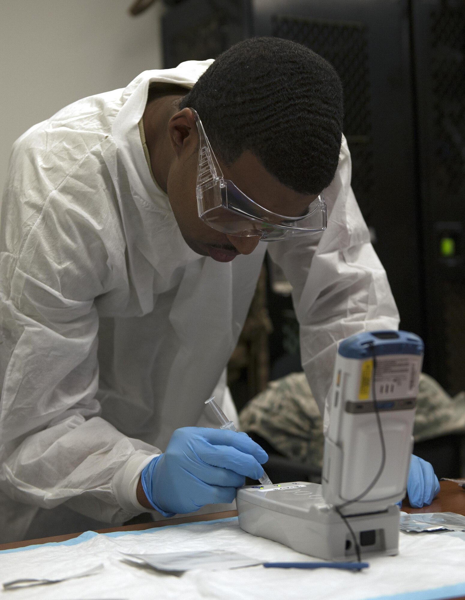 Senior Airman Joseph Tapp, 1st Special Operation Medical Support Squadron lab technician, tests the capabilities of the EPOC, a portable blood analyzer, on Hurlburt Field, Fla., Dec. 17, 2014. During the evaluation, personnel conducted various tests on the EPOC to see how it matched to the iSTAT, a blood analyzer model currently employed throughout the Air Force.    (U.S. Air Force photo/ Staff Sgt. Kentavist P. Brackin)