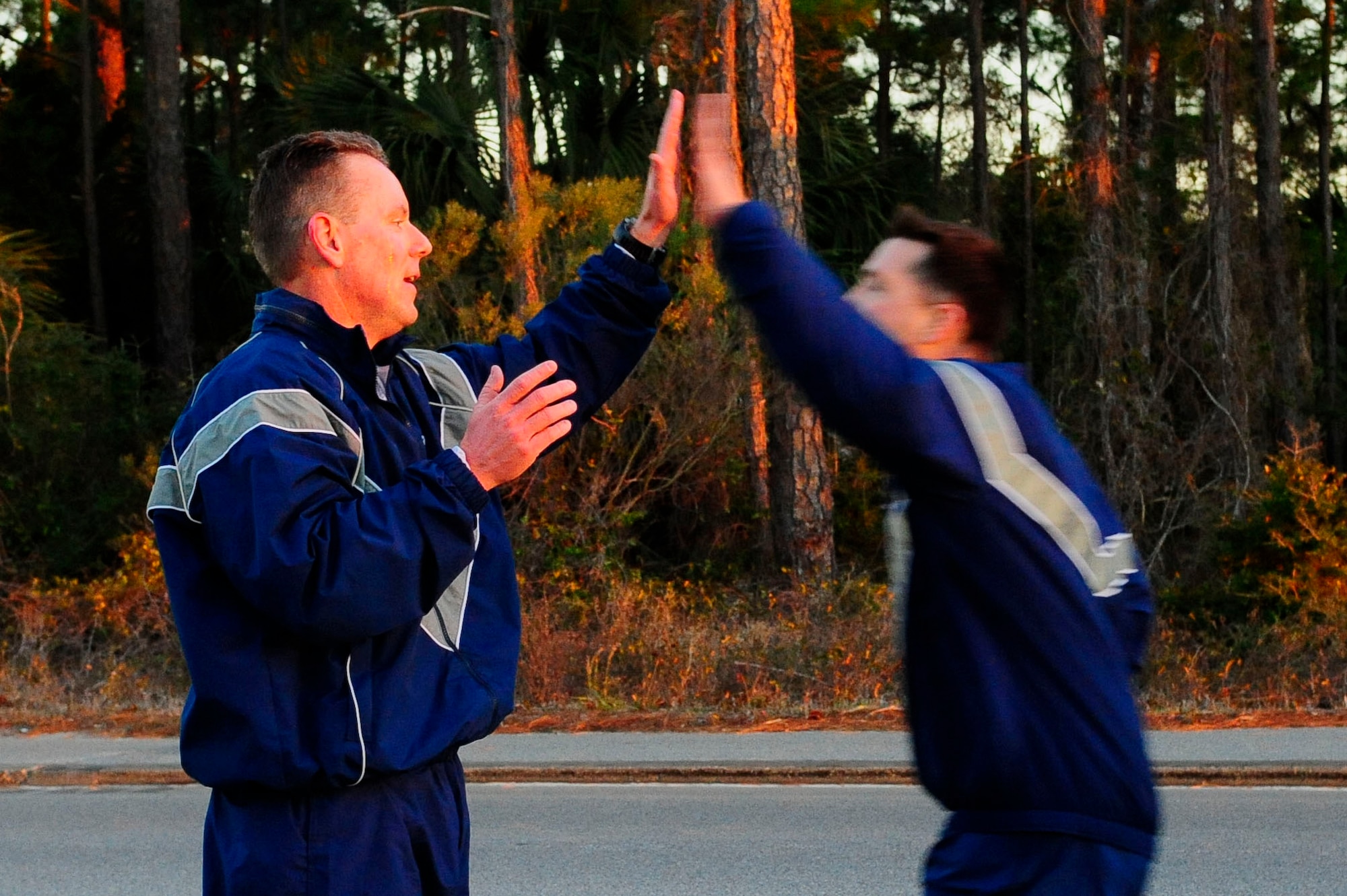 Chief Master Sgt. Cory Olson, 1st Special Operations Wing command chief, high fives runners after a two mile run for the 2015 AFSOC Chiefs Orientation at Hurlburt Field, Fla., Jan. 27, 2015. The Air Force Personnel Center said 2,525 senior master sergeants were eligible for promotion, resulting in a selection rate of 18.97 percent. (U.S. Air Force photo/Airman 1st Class Andrea Posey)
