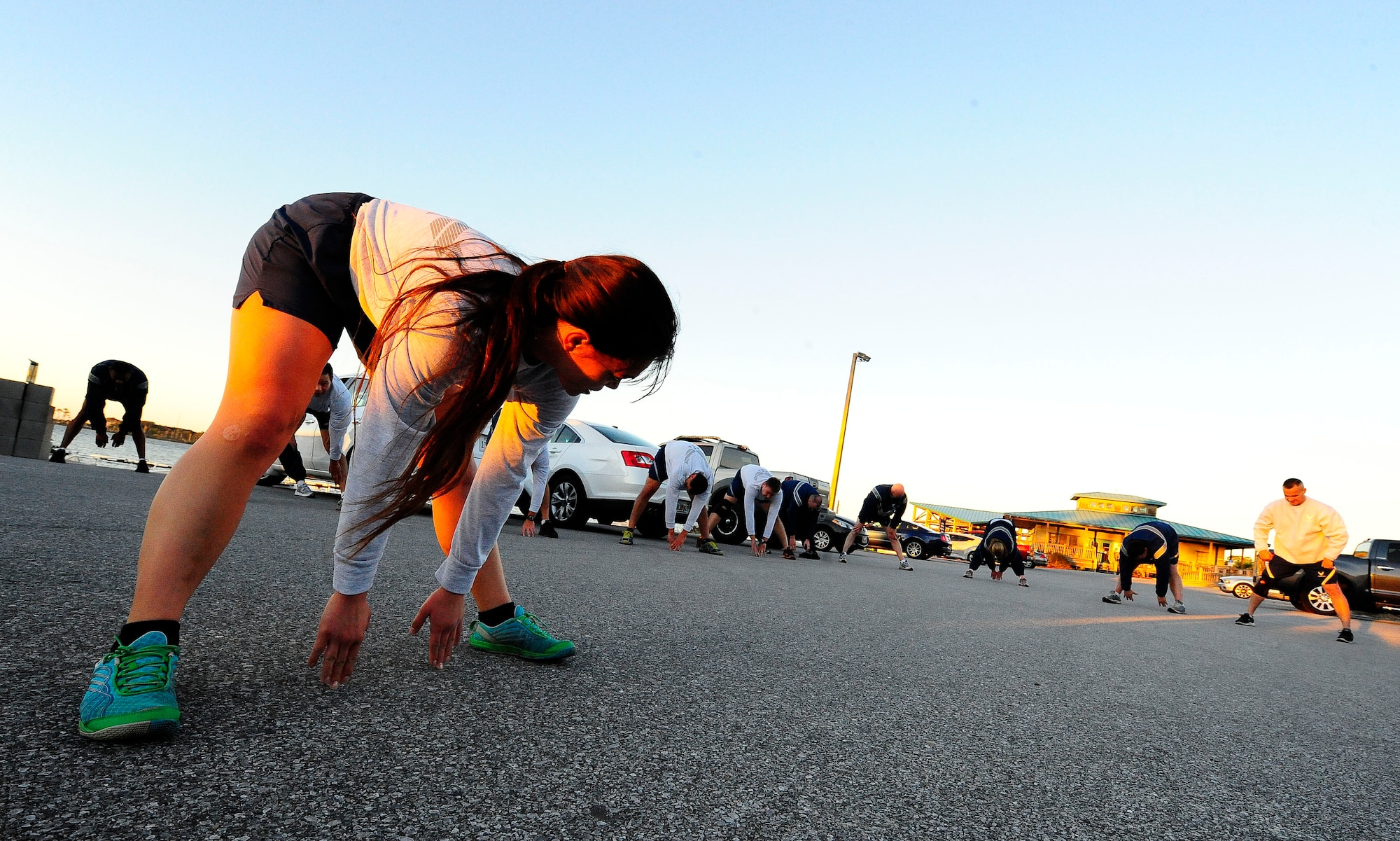 Senior Airman Deanna Bruce, 2nd Combat Weather Systems Squadron weather systems technician, leads stretches after a work-out for the 2015 AFSOC Chiefs Orientation on Hurlburt Field, Fla., Jan. 27, 2015. Chief Master Sgt. Matthew Caruso, Air Force Special Operations Command command chief, was the host for this year’s event.  (U.S. Air Force photo/Airman 1st Class Andrea Posey) 