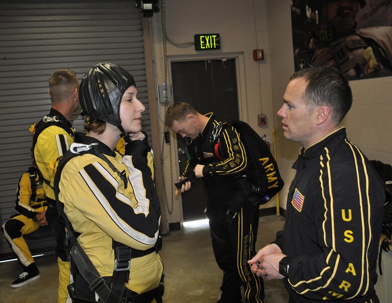 Sgt. 1st Class Jon Ewald, tandem instructor with the U.S. Army Parachute Team: The Golden Knights, gives some pre-jump instruction to Maj. Brooke Cortez, 482nd Fighter Wing Public Affairs chief, prior to a tandem jump at Homestead Air Reserve Base, Fla., on Jan. 29. The Golden Knights are conducting their sixth straight year of winter training at Homestead ARB. (U.S. Air Force photo/Tim Norton)