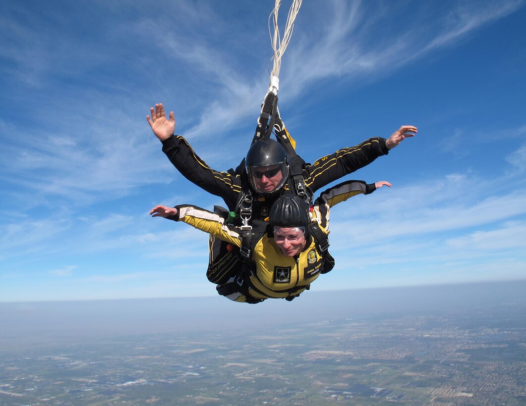Sgt. 1st Class Jon Ewald, tandem instructor with the U.S. Army Parachute Team: The Golden Knights, and Maj. Brooke Cortez, 482nd Fighter Wing Public Affairs chief, conduct a tandem jump high over Homestead Air Reserve Base, Fla., on Jan. 29. The Golden Knights are conducting their sixth straight year of winter training at Homestead ARB. (U.S. Army photo/Sgt. Trey Martin) 