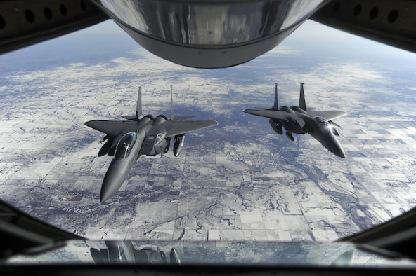 Two F-15E Strike Eagles wait to receive fuel from a KC-135R Stratotanker Jan. 23, 2015, on their way to Nellis Air Force Base, Nev., in support of Red Flag 15-1. The exercise, featuring aircraft from 21 different Air Force squadrons, offers realistic combat training involving the air, space and cyber forces of the U.S. and its allies. The F-15s are assigned to the 4th Fighter Wing and the KC-135R is assigned to the 916th Air Refueling Wing. (U.S. Air Force photo/Airman 1st Class Aaron J. Jenne)