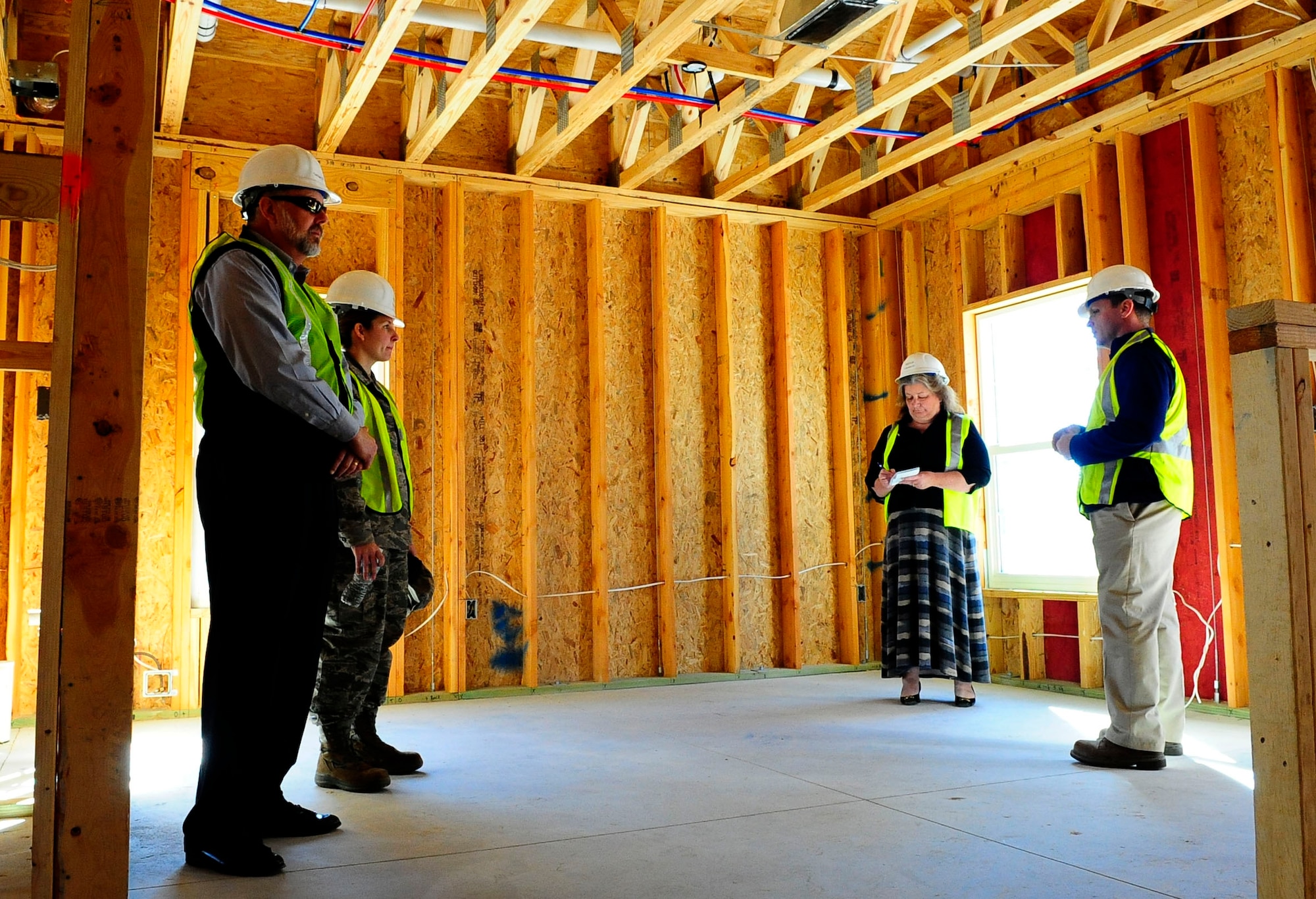 Construction leaders give a tour of a house in the Osprey Landing neighborhood at Hurlburt Field, Fla., Jan. 28, 2015. After the wiring is finished, insulation, carpeting and amenities will be installed. (U. S. Air Force photo/Airman 1st Class Andrea Posey)