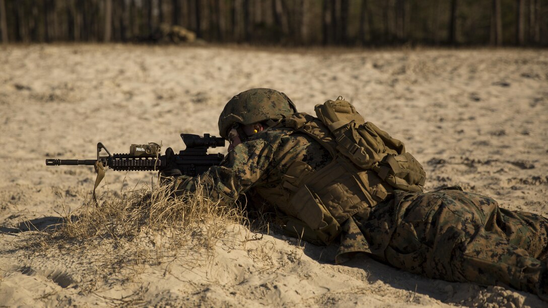A Marine with 2nd Reconnaissance Battalion, 2nd Marine Division provides suppressing fire while fellow Marines bound back to break contact with a superior force during the simulated training exercise aboard Camp Lejeune, N.C., Jan. 21, 2015. The Marines would conduct a patrol down range, the range targets would pop up simulating enemy targets, and then they would cover and move back down the range to elude the enemy force that, in this scenario, is superior. (U.S. Marine Corps photo by Lance Cpl. Justin T Updegraff/ Released)