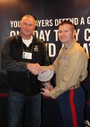 Capt. Joseph Haley, operations officer, RS Indianapolis, shakes the hand of Semper Fidelis Coach award winner Mark Bless, head football coach, Avon High School, Avon, IN, at the 2015 Glazier Coaches Clinics in Indianapolis Jan. 24. Coach Bless received the award for demonstrating the Marine Corps core values of honor, courage and commitment both on and off the football field.