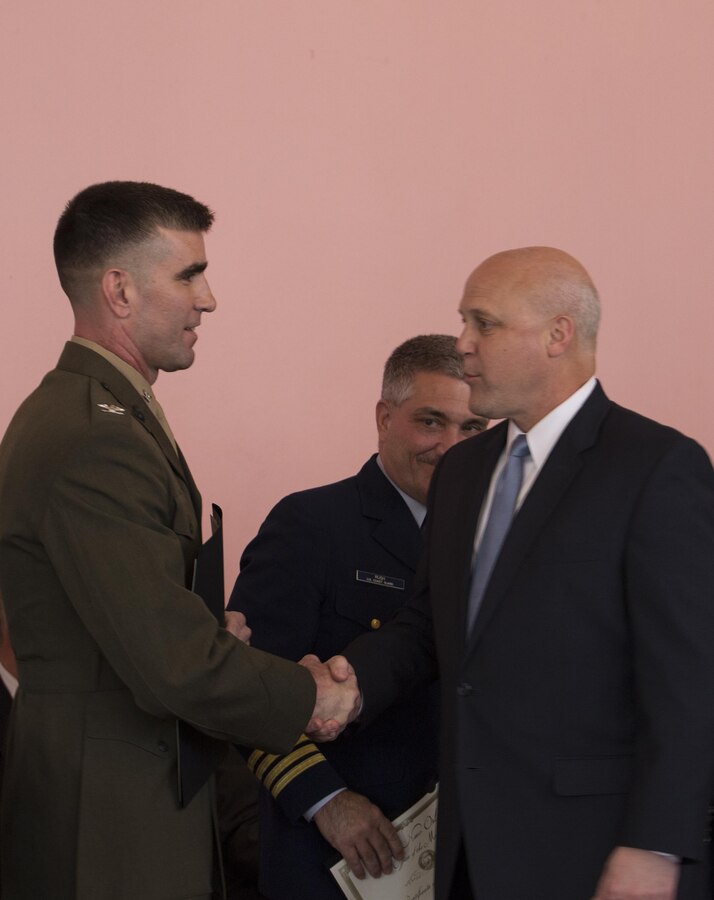 Col. Steven G. Godinho (left), commanding officer of Headquarters Battalion, Marine Forces Reserve, accepts a certificate of recognition from Mitch Landrieu (right), mayor of New Orleans, at Gallier Hall, Jan. 29, 2015. Godinho accepted the certificate on behalf of MARFORRES for its efforts in combating veteran homelessness in the New Orleans area. (U.S. Marine Corps photo by Cpl. Ian Leones)