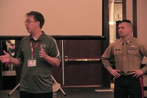 Capt. Joseph Haley, operations officer, RS Indianapolis, is introduced before the Semper Fi Coaches Award ceremony at the 2015 Glazier Coaches Clinics in Indianapolis Jan. 24, 2015