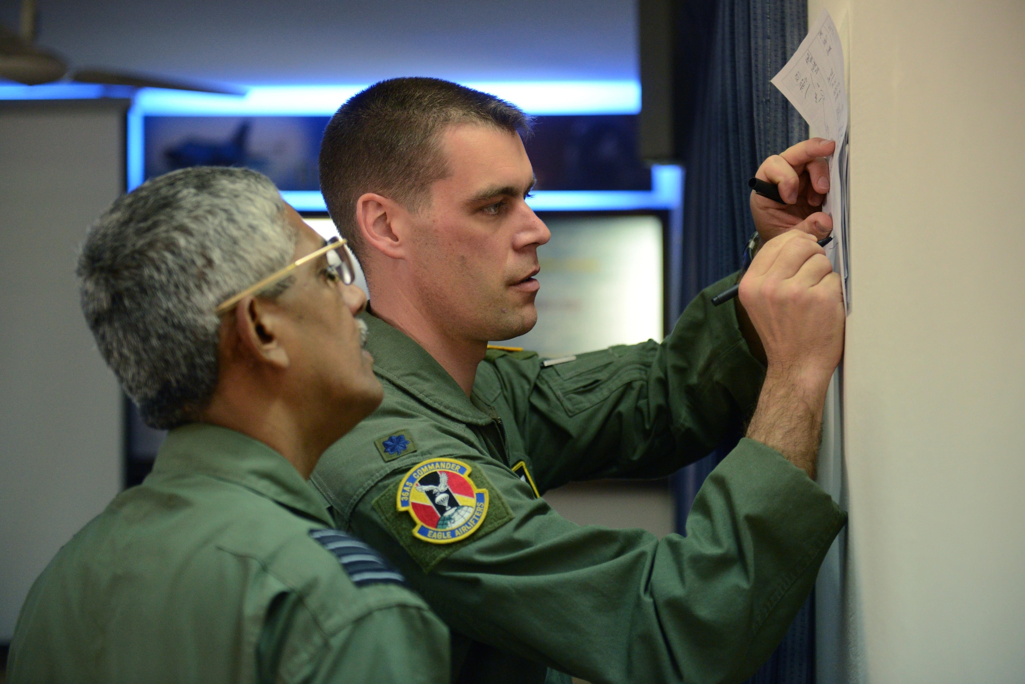 Lt. Col. Andrew Campbell, right, discusses a mission with Bangladesh air force Group Captain Awal Hossain during Cope South 15 Jan. 28, 2015, at BAF Base Bangabandhu, Bangladesh. Cope South is a Pacific Air Forces-sponsored, bilateral tactical airlift exercise conducted in Bangladesh, with a focus on cooperative flight operations, day and night low-level navigation, tactical airdrop, and air-land missions; as well as subject matter expert exchanges in the fields of operations, maintenance and rigging disciplines. Campbell is the 36th Airlift Squadron commander at Yokota Air Base, Japan. (U.S. Air Force photo/1st Lt. Jake Bailey)