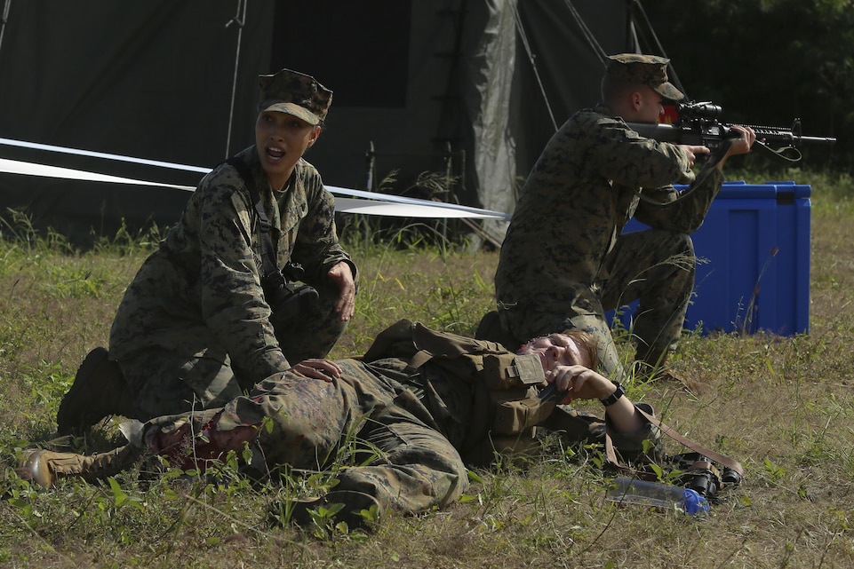 A Marine from Combat Logistics Battalion 3 calls for a corpsman to help treat a casualty during a battalion field exercise, Jan. 27, 2015, after her unit’s simulated forward operating base was attacked at Marine Corps Training Area Bellows. The battalion tested their emergency response in several areas, including a mass casualty drill. (U.S. Marine Corps photo by Lance Cpl. Khalil Ross/released)