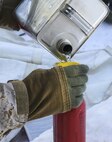 A U.S. Marine with Combat Logistics Battalion 26, Headquarters Regiment, 2nd Marine Logistics Group, refills his supply of white fuel during a training exercise aboard U.S. Marine Corps Mountain Warfare Training Center at Bridgeport, California, Jan. 24, 2015. The Marines used the fuel to ignite flames in their portable stoves, providing heat for potable water and warm food. (U.S. Marine Corps photo by Lance Cpl. Kaitlyn Klein/Released)