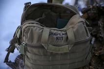 U.S. Navy Lt. Todd Mallory, a Chaplain with Combat Logistics Battalion 26, Headquarters Regiment, 2nd Marine Logistics Group, prepares his Chaplain kit before conducting a sermon at U.S. Marine Corps Mountain Warfare Training Center aboard Bridgeport, California, Jan. 24, 2015. The chaplain kit is a weather-resistant bag used to transport supplies to conduct sermons and provide religious support in the field. (U.S. Marine Corps photo by Lance Cpl. Kaitlyn Klein/Released)