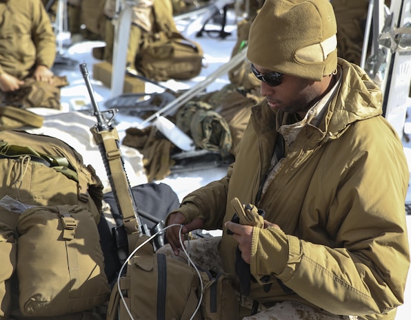 Sgt. Robert Reese III, a distribution management specialist with Combat Logistics Battalion 26, Headquarters Regiment, 2nd Marine Logistics Group, stores supplies in his main pack before a movement during a training exercise aboard U.S. Marine Corps Mountain Warfare Training Center at Bridgeport, California, Jan. 26, 2015. The Marines packed only the bare essentials needed to survive for two nights in the mountains. (U.S. Marine Corps photo by Lance Cpl. Kaitlyn Klein/Released)