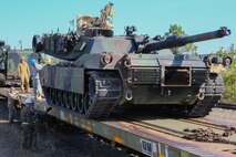 Marines with II Marine Logistics Group and soldiers with Movement Control Company 171 inspect the position of an M1A1 Abrams before securing it to a rail car during a railway operation training course aboard Marine Corps Base Camp Lejeune, N.C., Jan. 21, 2015. The training involved learning to organize, load and secure vehicles and equipment on the correct weight-rated rail cars to transport each item safely. (U.S. Marine Corps photo by Lance Cpl. Sullivan Laramie)