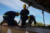 Marines with Combat Logistics Battalion 2 secure an amphibious assault vehicle to a rail car during a railway operation training course aboard Marine Corps Base Camp Lejeune, N.C., Jan. 21, 2015. During railway operations, each vehicle, piece of equipment and cargo container must be placed and chained to a predetermined part of the rail car to avoid damage caused by movement. (U.S. Marine Corps photo by Lance Cpl. Sullivan Laramie)