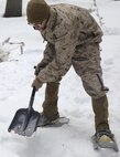 Petty Officer 3rd Class Jonathan Elliott, a religious program specialist with Headquarters and Service Company, Combat Logistics Battalion 26, 2nd Marine Logistics Group, digs out the foundation for his fire team’s combat tent during a training exercise aboard U.S. Marine Corps Mountain Warfare Training Center in Bridgeport, California, Jan. 20, 2015. The Marines were instructed to dig close to the ground without catching any dirt, in order to not compromise their position. (U.S. Marine Corps photo by Lance Cpl. Kaitlyn Klein/Released)