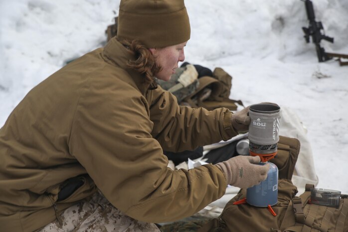 Maj. Brooke Speers, the executive officer of Combat Logistics Battalion 26, Headquarters Regiment, 2nd Marine Logistics Group, heats snow for drinking water in a jet boil after setting up her tent during a training exercise aboard U.S. Marine Corps Mountain Warfare Training Center in Bridgeport, California, Jan. 20, 2015. The Marines boiled handfuls of untouched snow, and then strained the purified water through a coffee filter into nalgene bottles for fresh drinking water. (U.S. Marine Corps photo by Lance Cpl. Kaitlyn Klein/Released)