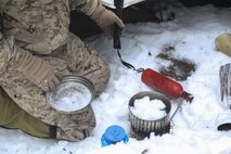 A Marine with Combat Logistics Battalion 26, Headquarters Regiment, 2nd Marine Logistics Group, melts snow for drinking water in a portable stove during a training exercise aboard U.S. Marine Corps Mountain Warfare Training Center in Bridgeport, California, Jan. 20, 2015. The Marines maintained a potable source of water not only for drinking, but for re-hydrating their Cold-Weather Meals Ready-To-Eat, as well. (U.S. Marine Corps photo by Lance Cpl. Kaitlyn Klein/Released)