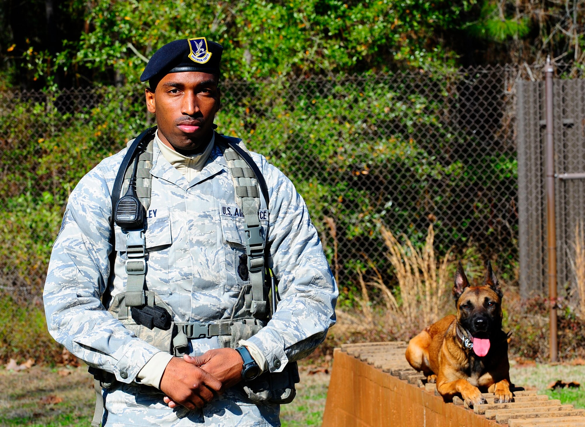 Staff Sgt. Terrell Beasley, 1st Special Operations Security Forces Squadron military working dog handler, stands with his dog at Hurlburt Filed, Fla., Jan. 29, 2015. Beasley is the first handler in Air Force Special Operations Command to complete the Alcohol, Tobacco, Firearms and Explosive, National Odor Recognition Testing. (U. S. Air Force photo/ Airman 1st Class Andrea Posey)