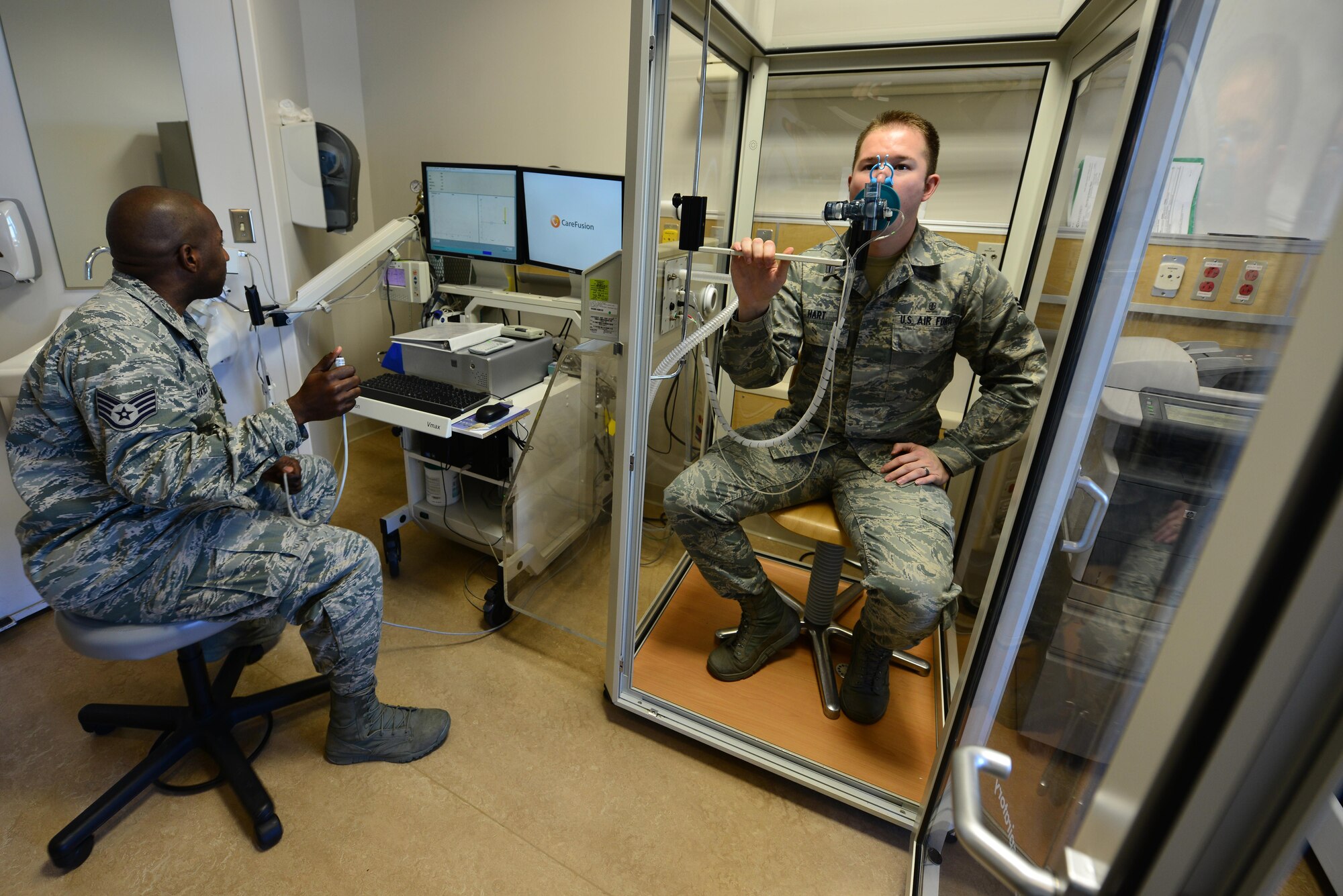 Staff Sgt. Arjune Haynes directs Senior Airman Robert Hart through a pulmonary function test Jan. 16, 2015, at Langley Air Force Base, Va. After multiple failed attempts at the Armed Services Vocational Aptitude Battery and being disqualified during his physical, Haynes, a native of Panama, thought his dream of becoming an American Airman were out of reach. Now an Airman of eight years, Haynes said he tells the younger Airmen he comes in contact with to never take no for an answer. Haynes is the 633rd Medical Operations Squadron cardiopulmonary services assistant NCO in charge and Hart is an 633rd MDOS cardiopulmonary technician. (U.S. Air Force photo/Senior Airman Aubrey White)