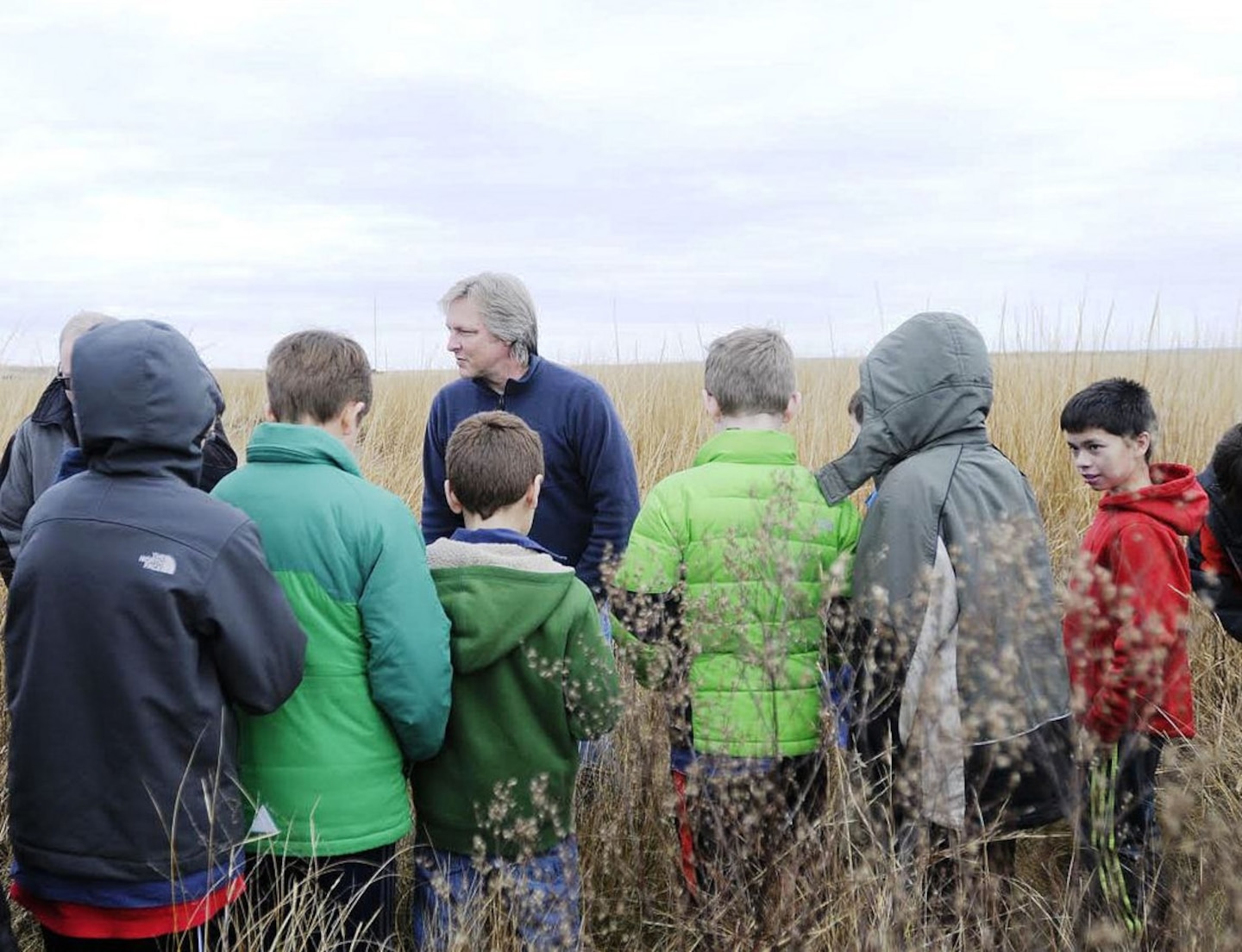 Poplar Island Project Manager Justin Callahan, U.S. Army Corps of Engineers, Baltimore District, explains the purpose of the various grasses that have been planted on the island as part of habitat restoration efforts. 