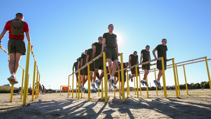 Sgt. John D. Weltzin, drill instructor, Delta Company, 1st Recruit Training Battalion, performs dips with recruits during interval training at Marine Corps Recruit Depot San Diego, Jan. 15.  During the event, recruits completed two half-mile sprints followed by a circuit course compiled of multiple stations such as inside and outside rotations, step-ups, dips, monkey bars, leg lifts, straight bar curls, crunches, upright rows and overhead presses.  