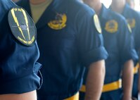 The specially designed squadron patch was put on the dedicated crew chiefs’ uniforms during a recognition ceremony at Luke Air Force Base, Arizona, Jan. 23, 2015. Seventeen dedicated crew chiefs were each assigned an F-35 Lightning II joint strike fighter. (U.S. Air Force photo/Senior Airman Devante Williams)