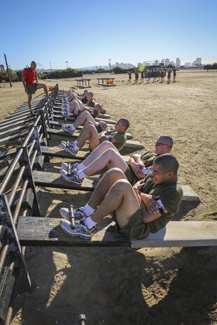 Recruits of Delta Company, 1st Recruit Training Battalion, perform incline crunches during interval training at Marine Corps Recruit Depot San Diego, Jan. 15.  Although recruits arrive at the depot at different physical fitness levels, the training schedule is geared to help recruits reach the Corps’ physical standards and prepare them for future deployments.