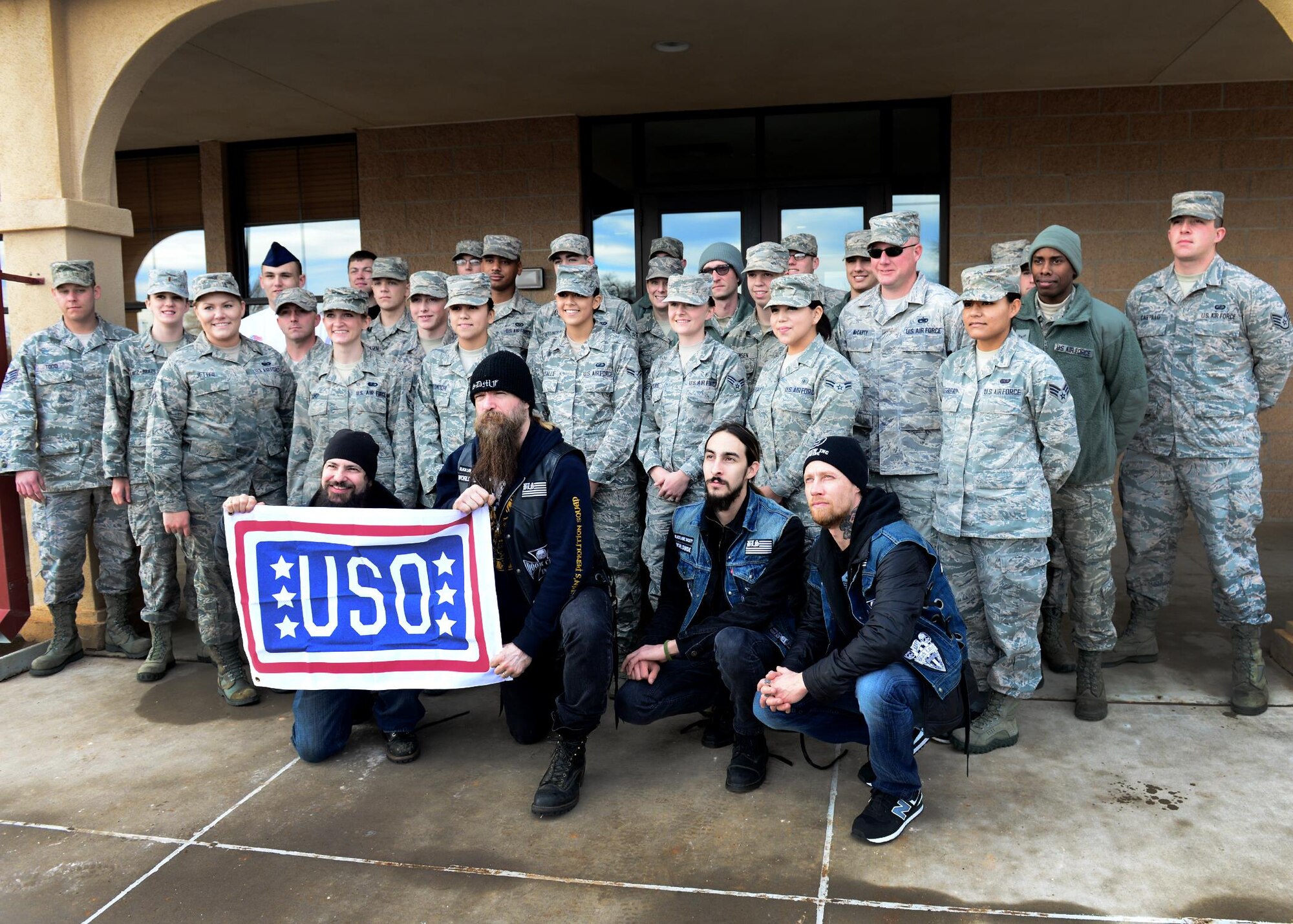 U.S. Air Force Air Commandos with the 27th Special Operations Wing gather for a group photo after breakfast with the Black Label Society outside the Pecos Trail Dining Facility Jan. 28, 2015 at Cannon Air Force Base, N.M. The band was afforded an opportunity to dine with recent award winners from around the wing before their tour of the installation. (U.S. Air Force photo/Airman 1st Class Shelby Kay-Fantozzi) 
