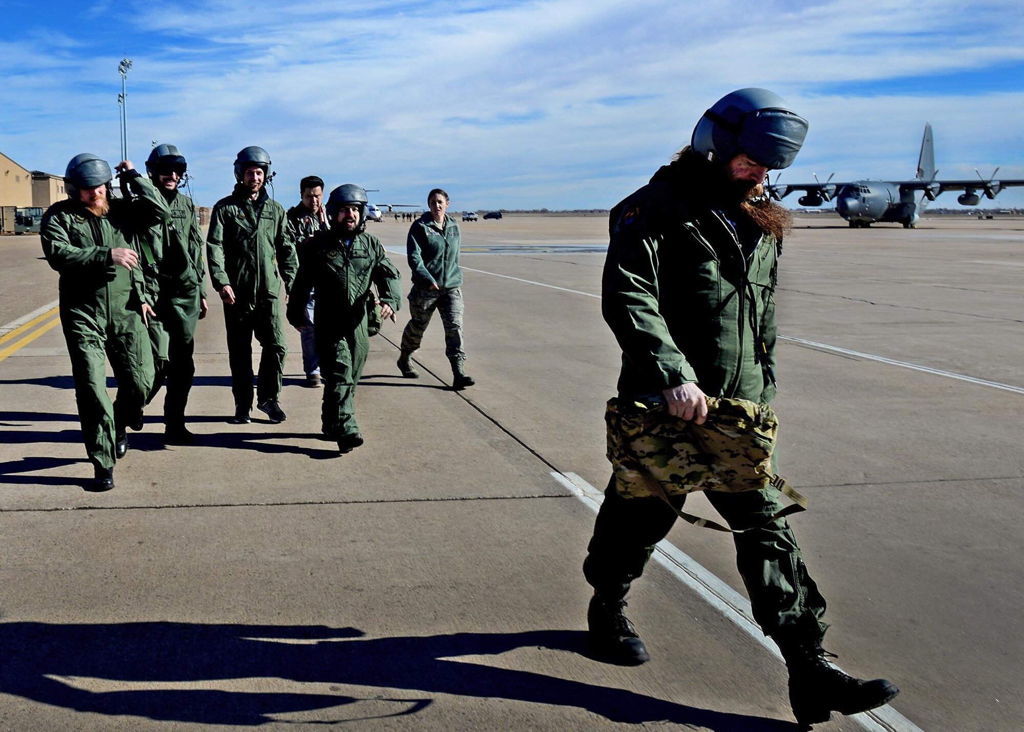 The Black Label Society walks across the flightline geared-up to board an aircraft Jan. 28, 2015 at Cannon Air Force Base, N.M. The band was provided an orientation flight on an AC-130W Stinger II as part of their tour of the base prior to their live performance later that evening. (U.S. Air Force photo/Airman 1st Class Shelby Kay-Fantozzi) 