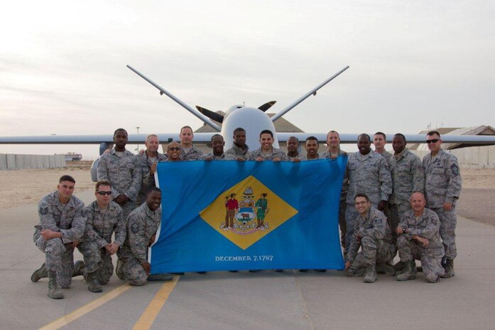 Airmen of the166th Civil Engineer Squadron, 166th Airlift Wing, Delaware Air National Guard, pose while deployed to an undisclosed location in Southwest Asia on Jan. 5, 2015. Kneeling, L to R: Tech. Sgt. Joe Sparacio, Tech. Sgt. Sean Cline, Master Sgt. Maurice Williams, Staff Sgt. Bob Natale, Tech. Sgt. Mike Lawson. Standing, L to R: Senior Airman Brent Green, Master Sgt. Mike Caldwell, Senior Airman Kirk Phang, Master Sgt. Greg Lichtner, Senior Airman James Barnes, Staff Sgt. Kenrick Gray, Senior Airman Jeremy Burgos, Senior Airman Durrelle Petty, Senior Airman Joe Gilford, Staff Sgt. Andy Steward, Tech. Sgt. Hilton William, Staff Sgt. Shawn Moore, Senior Airman Josh Robbins, Chief Master Sgt. Lorne Peterson (U.S. Air National Guard courtesy photo)