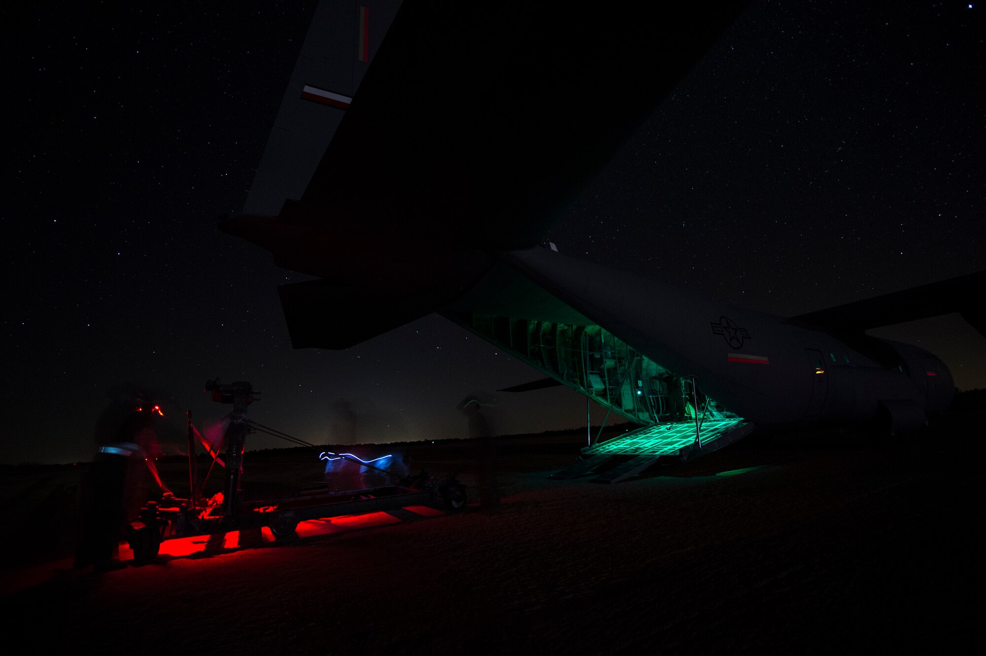 Members of the 817th Contingency Response Group train at night using night vision goggles at the Joint Readiness Training Center exercise at Ft. Polk, La., Jan. 18, 2015. JRTC is a 34th Combat Training Squadron exercise for the U.S. Army that improves unit readiness by providing realistic, stressful, joint and combined arms training across the full spectrum of conflict. The Airmen helped support the exercise, and also provided an opportunity for internal training. (U.S. Air Force photo/Staff Sgt. Gustavo Gonzalez/RELEASED)