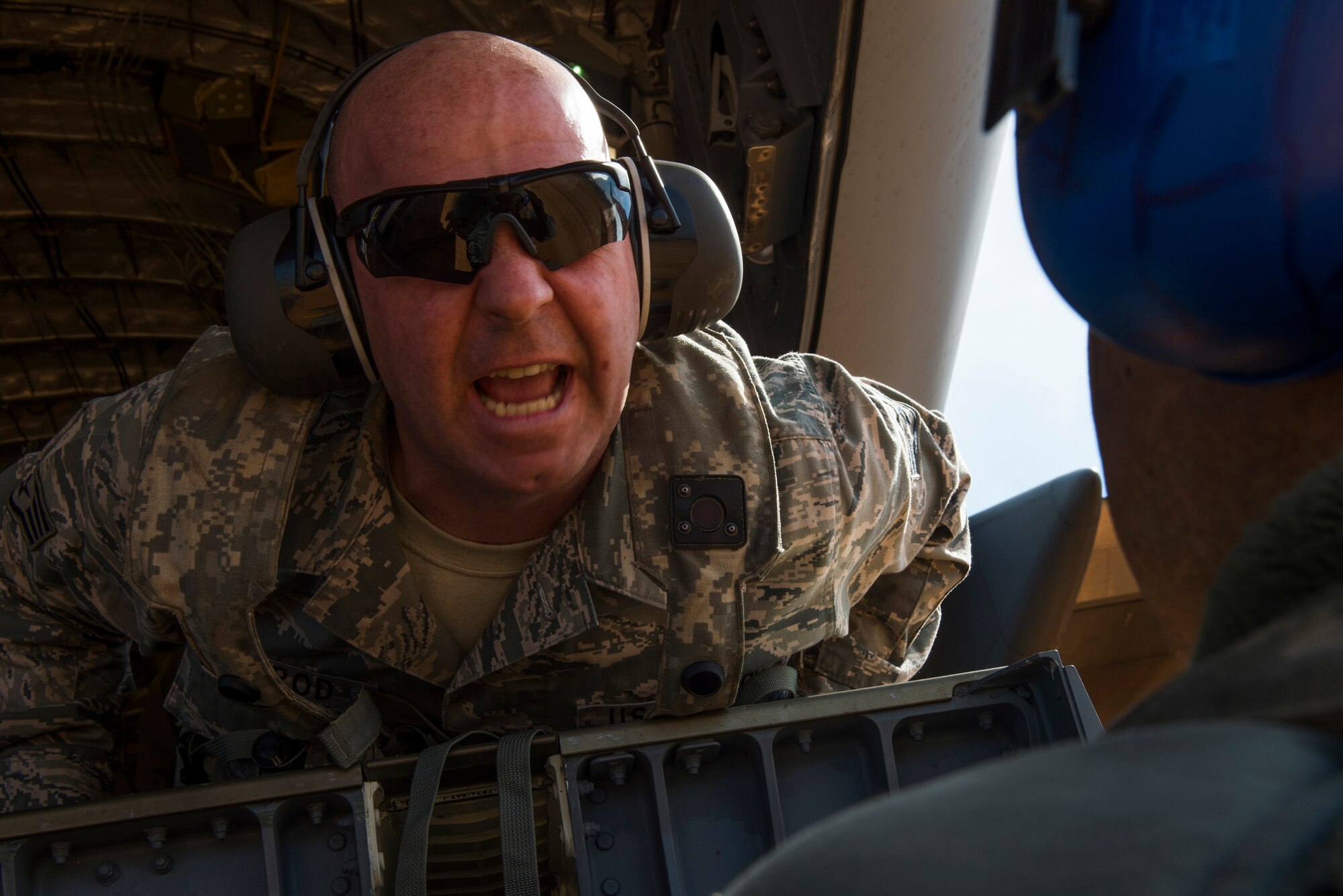 Staff Sgt. Thomas Sherrod, 817th Contingency Response Group aerial porter stationed at Joint Base McGuire-Dix-Lakehurst, N.J., speaks to an Airmen during a  training exercise at the Joint Readiness Training Center at Fort Polk, La., Jan. 17, 2015. JRTC is a 34th Combat Training Squadron exercise for the U.S. Army that improves unit readiness by providing realistic, stressful, joint and combined arms training across the full spectrum of conflict. The Airmen helped support the exercise, and also provided an opportunity for internal training. (U.S. Air Force photo/Staff Sgt. Gustavo Gonzalez/RELEASED)