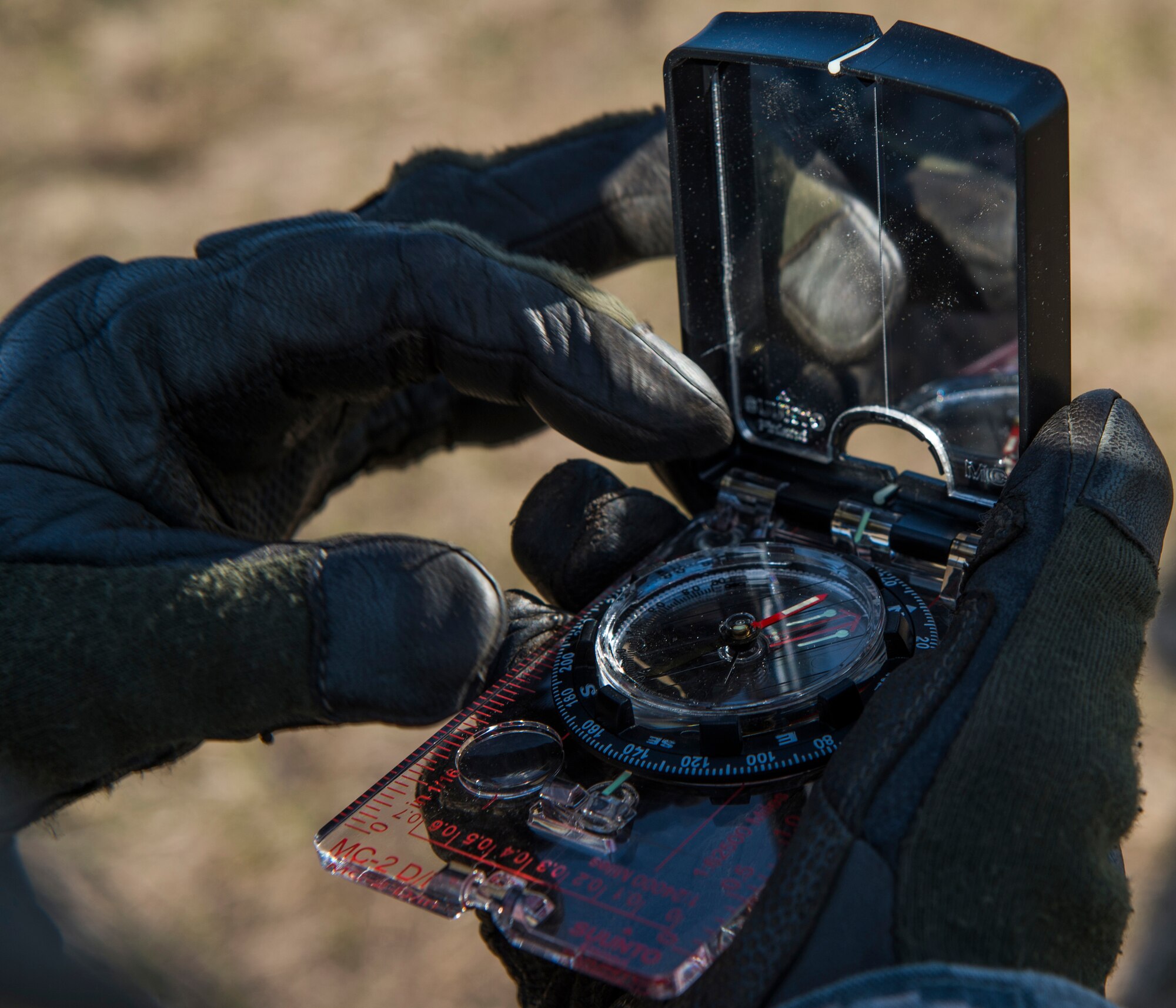 A member of the 817th Contingency Response Group reads a compass during a training exercise at the Joint Readiness Training Center at Fort Polk, La., Jan. 17, 2015. JRTC is a 34th Combat Training Squadron exercise for the U.S. Army that improves unit readiness by providing realistic, stressful, joint and combined arms training across the full spectrum of conflict. The Airmen helped support the exercise, and also provided an opportunity for internal training. (U.S. Air Force photo/Staff Sgt. Gustavo Gonzalez/RELEASED)