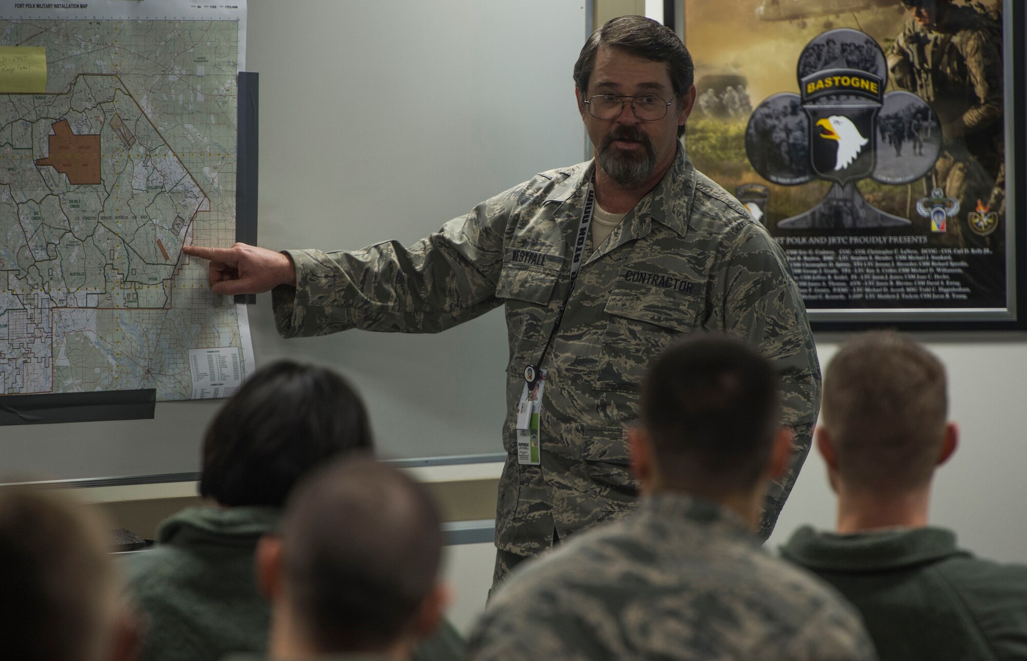Bart Westfall, 34th Combat Training Squadron exercise planner assigned to Little Rock Air Force Base, Ark., briefs members of the 817th Contingency Response Group in a classroom before an exercise at the Joint Readiness Training Center at Fort Polk, La., Jan. 14, 2015. JRTC is a 34 CTS exercise for the U.S. Army that improves unit readiness by providing realistic, stressful, joint and combined arms training across the full spectrum of conflict. The Airmen helped support the exercise, and also provided an opportunity for internal training. (U.S. Air Force photo/Staff Sgt. Gustavo Gonzalez/RELEASED)