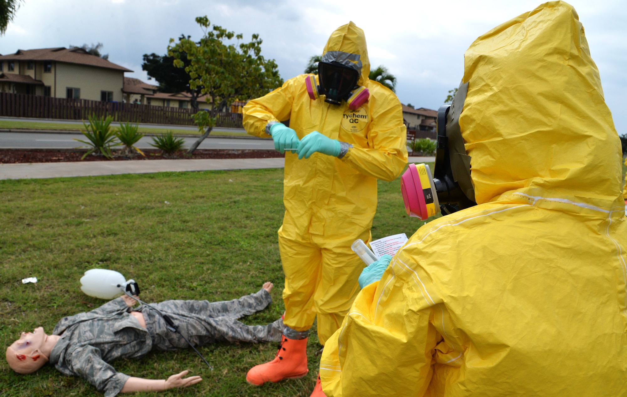 Airman 1st Class Christopher McCloud (left) and Tech. Sgt. Aubrey Pabon (right), 15th Aerospace Medicine Squadron bioenvironmental engineering flight, test for chemical contamination during integrated base emergency response capability training Jan. 30, 2015, at Joint Base Pearl Harbor-Hickam, Hawaii. The bioenvironmental engineering flight participated in the training Jan. 26-30. (U.S. Air Force photo by Staff Sgt. Alexander Martinez)