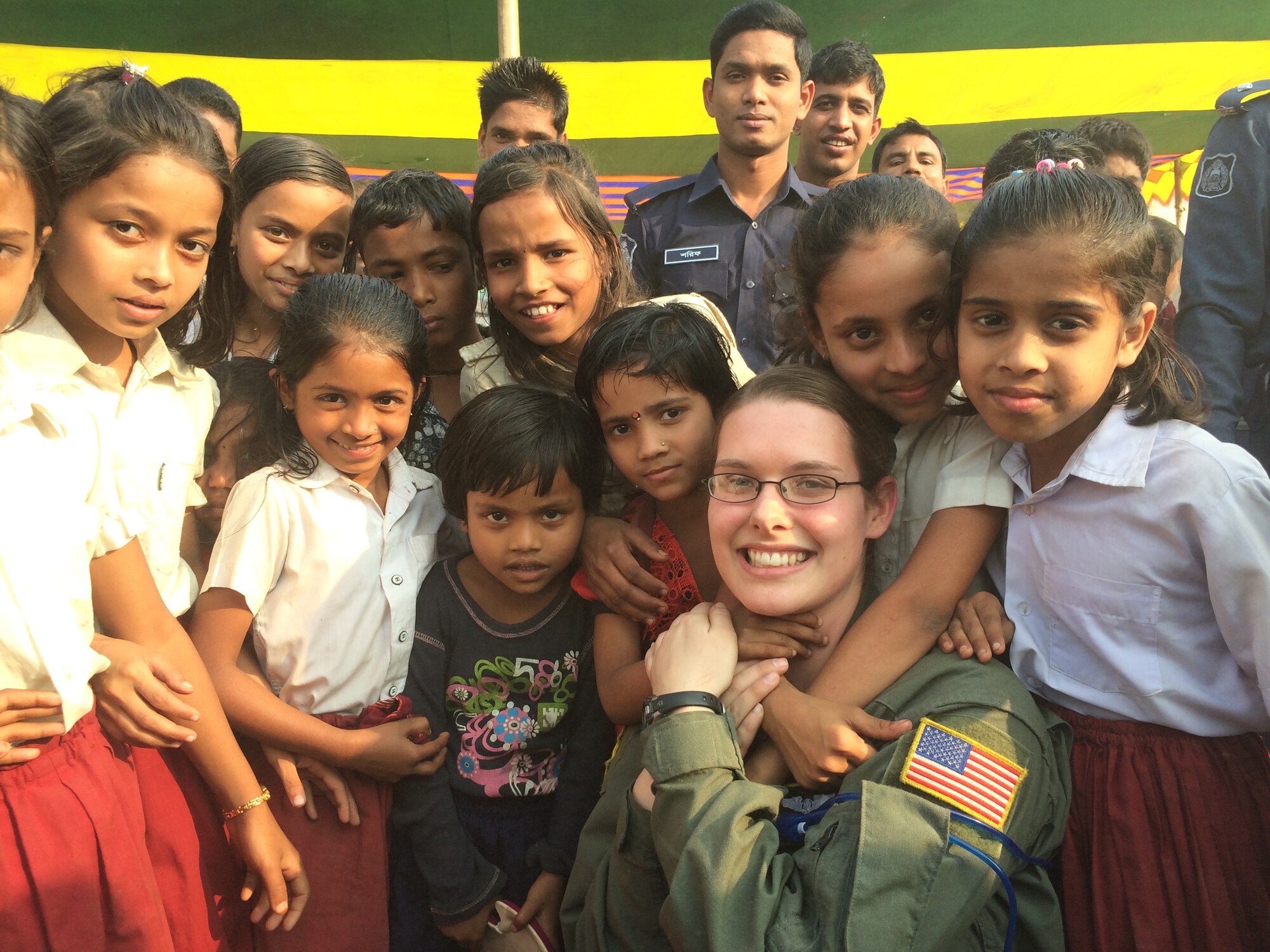 U.S. Air Force Senior Airman Taylor Hubstenberger takes a photo with students at Goainghat Primary School in Syhlet, Bangladesh during Exercise COPE SOUTH, Jan. 28, 2015. COPE SOUTH helps cultivate common bonds, foster goodwill, and improve readiness and compatibility between members of the Bangladesh and U.S. Air Forces. (U.S. Air Force photo by Senior Airman Ashley Powell/Released)