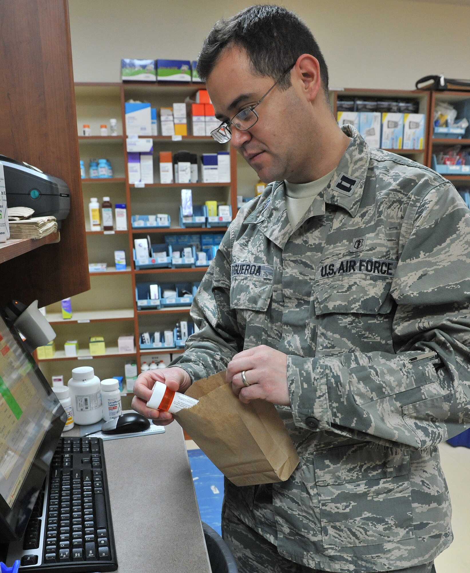 Capt. Arnaldo Figueroa, 341st Medical Support Squadron pharmacy flight commander, verifies prescription refills Jan. 27 at Malmstrom Air Force Base, Mont. As one of Malmstrom’s two pharmacists, Figueroa also manages anti-coagulation therapy for patients and administers the tobacco cessation medications for the 341st Medical Group’s tobacco cessation program. (U.S. Air Force photo/John Turner)