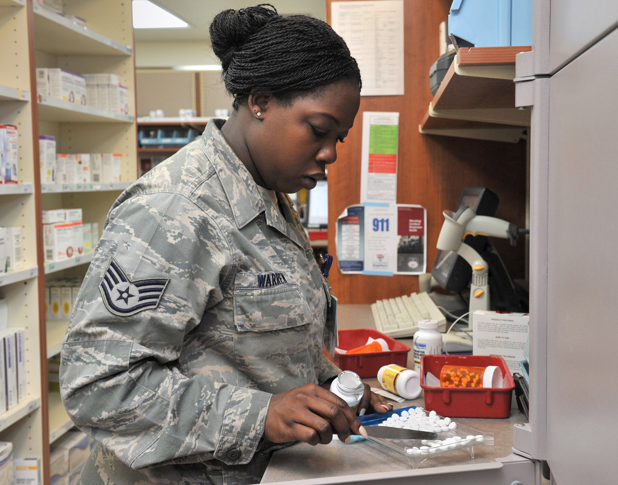 Staff Sgt. Latecia Warren, 341st Medical Support Squadron pharmacy technician, hand-counts pills while filling a prescription Jan. 27 at the Malmstrom Air Force Base, Mont., pharmacy. Warren is in charge of purchasing supplies and equipment for the pharmacy and oversees a $3.9 million budget. (U.S. Air Force photo/John Turner)