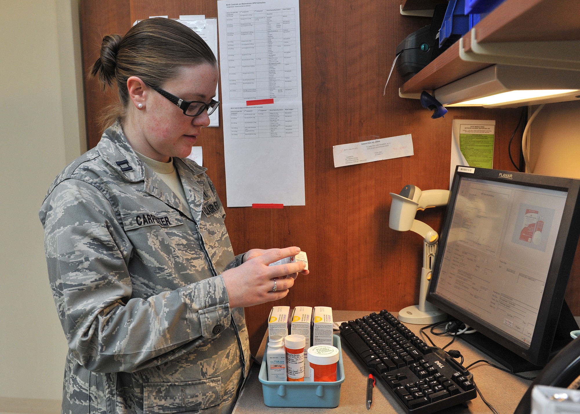 Capt. Julie Carpenter, 341st Medical Support Squadron pharmacist, verifies medications Jan. 27 at the Malmstrom Air Force Base, Mont., pharmacy.  Carpenter’s favorite part of her job is talking with patients about their therapies. She also confers with doctors, reports best practices within the pharmacy, and suggests items that can be added to the formulary. (U.S. Air Force photo/John Turner)