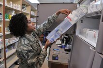 Tech. Sgt. Shontell Nelson, 341st Medical Support Squadron pharmacy flight chief, selects a bottle from the Malmstrom Air Force Base, Mont., pharmacy’s Pyxis CII Safe narcotics vault as she fills a prescription Jan. 26. The new safe automatically tracks the pharmacy’s inventory of controlled substances. (U.S. Air Force photo/John Turner)