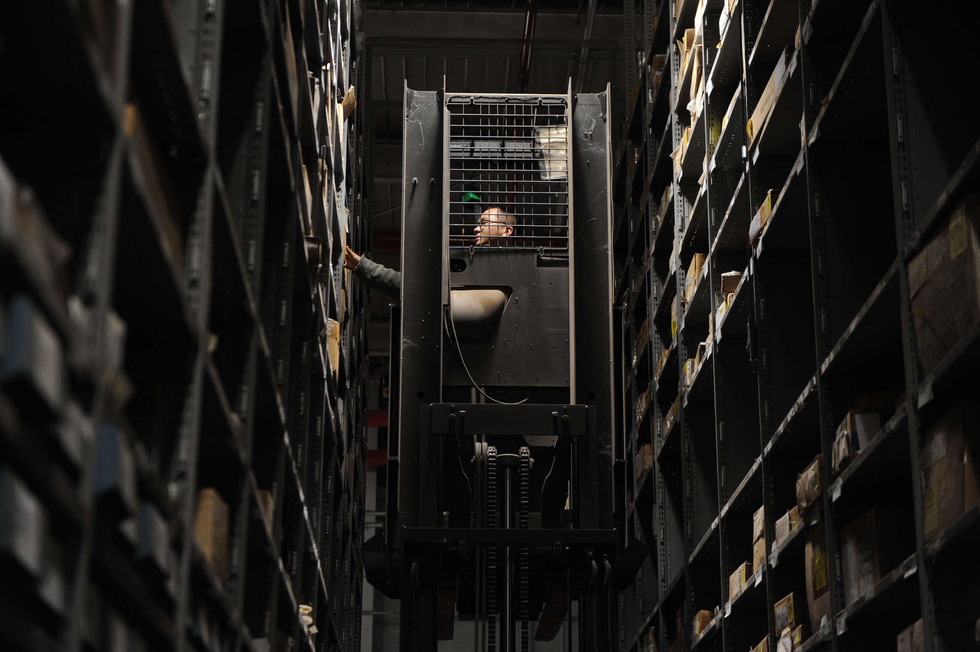 U.S. Air Force Airman 1st Class Vang Lee, 7th Logistic Readiness Squadron, storage and issue, uses a stock picker to reach the higher-level parts shelves in the main warehouse Jan. 8, 2015, at Dyess Air Force Base, Texas. Lee was responsible for consolidating and organizing more than 23,000 line codes with 116,000 parts during a parts transition from the B-1 Aircraft Parts Store to the main logistics warehouse. The move took place in order to streamline parts requisition for B-1 maintainers. (U.S. Air Force photo by Airman 1st Class Alexander Guerrero/Released)
