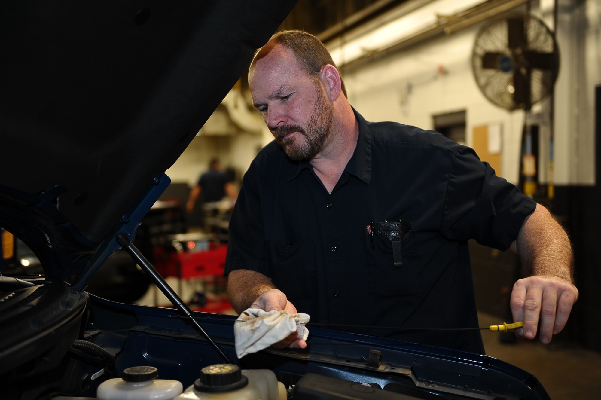 Patrick Fleming, 14th Logistics Readiness Squadron Heavy Mobile Equipment Mechanic, checks the oil of a government vehicle Jan. 27 on Columbus Air Force Base, Miss. 14th LRS Vehicle Management Flight is in charge of taking care of up to 175 vehicles on the installation. (U.S. Air Force photo/Airman Daniel Lile)