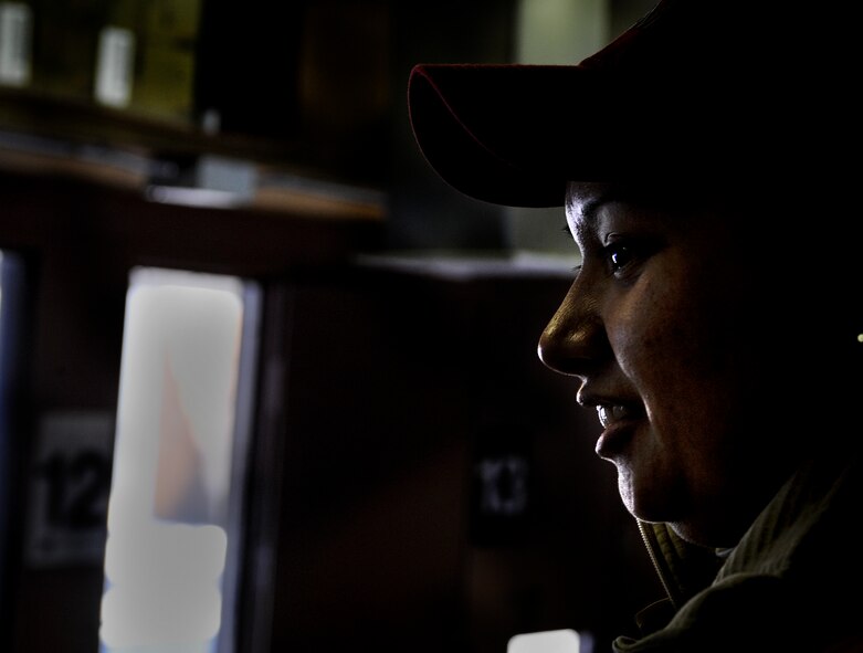 taff Sgt. Joanna Richmond, 5th Security Forces Squadron combat arms training and maintenance instructor, smiles at her students during M4 rifle training on Minot Air Force Base, N.D., Jan. 12, 2015. Richmond instructed the group on fundamentals in the classroom and oversaw the range for the practical portion of training. (U.S. Air Force photo/Senior Airman Stephanie Morris)