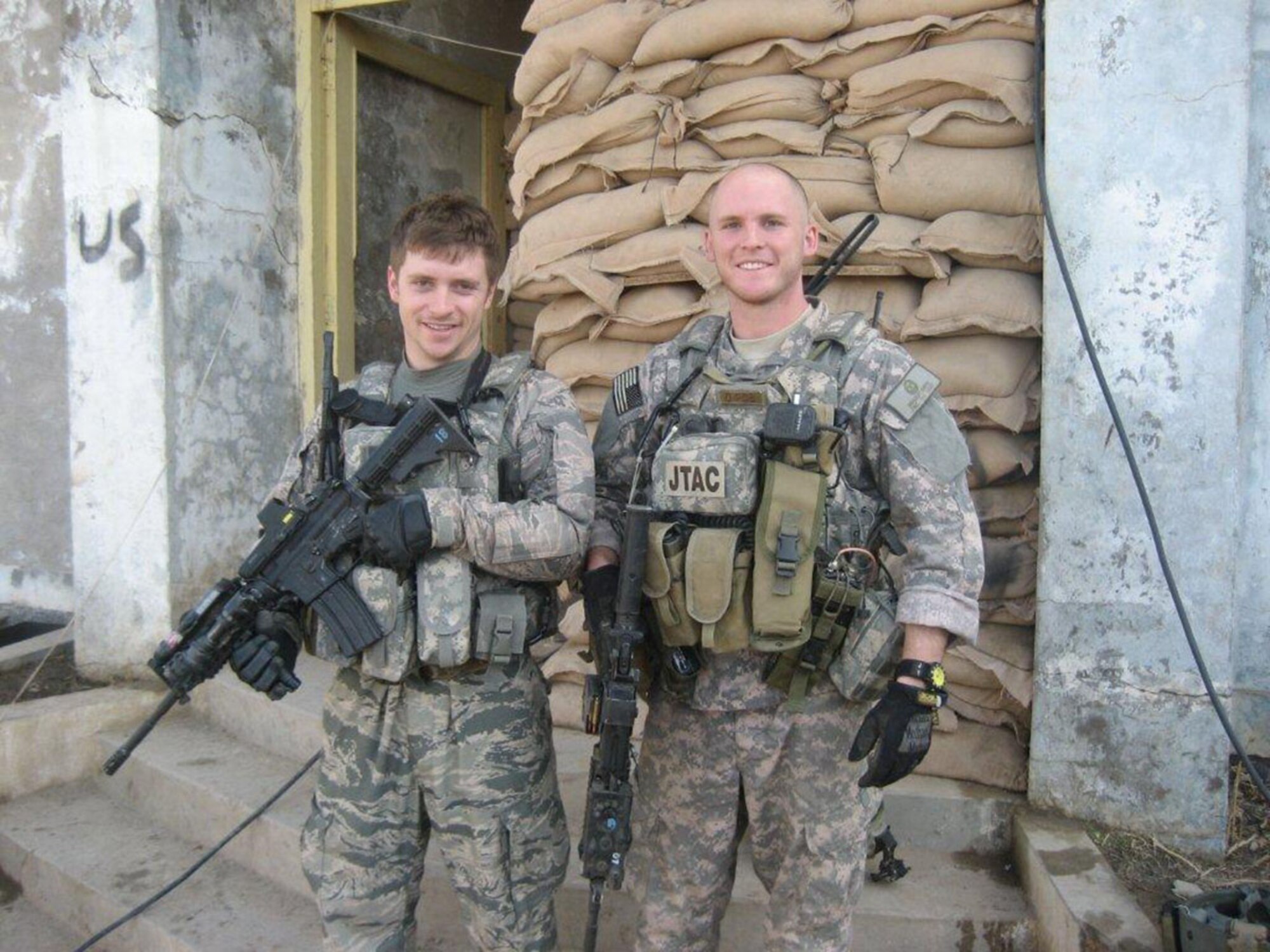An exhibit photo shows Senior Airmen Michael Malarsie (left) and Bradley Smith, who deployed together to Afghanistan in December 2009 as a 2-man TACP team from the 10th Air Support Operations Squadron embedded with an Army infantry company. Both were injured in 2010 by improvised explosive devices; Smith mortally so. (Cox Media Group photo by Ty Greenlees)
