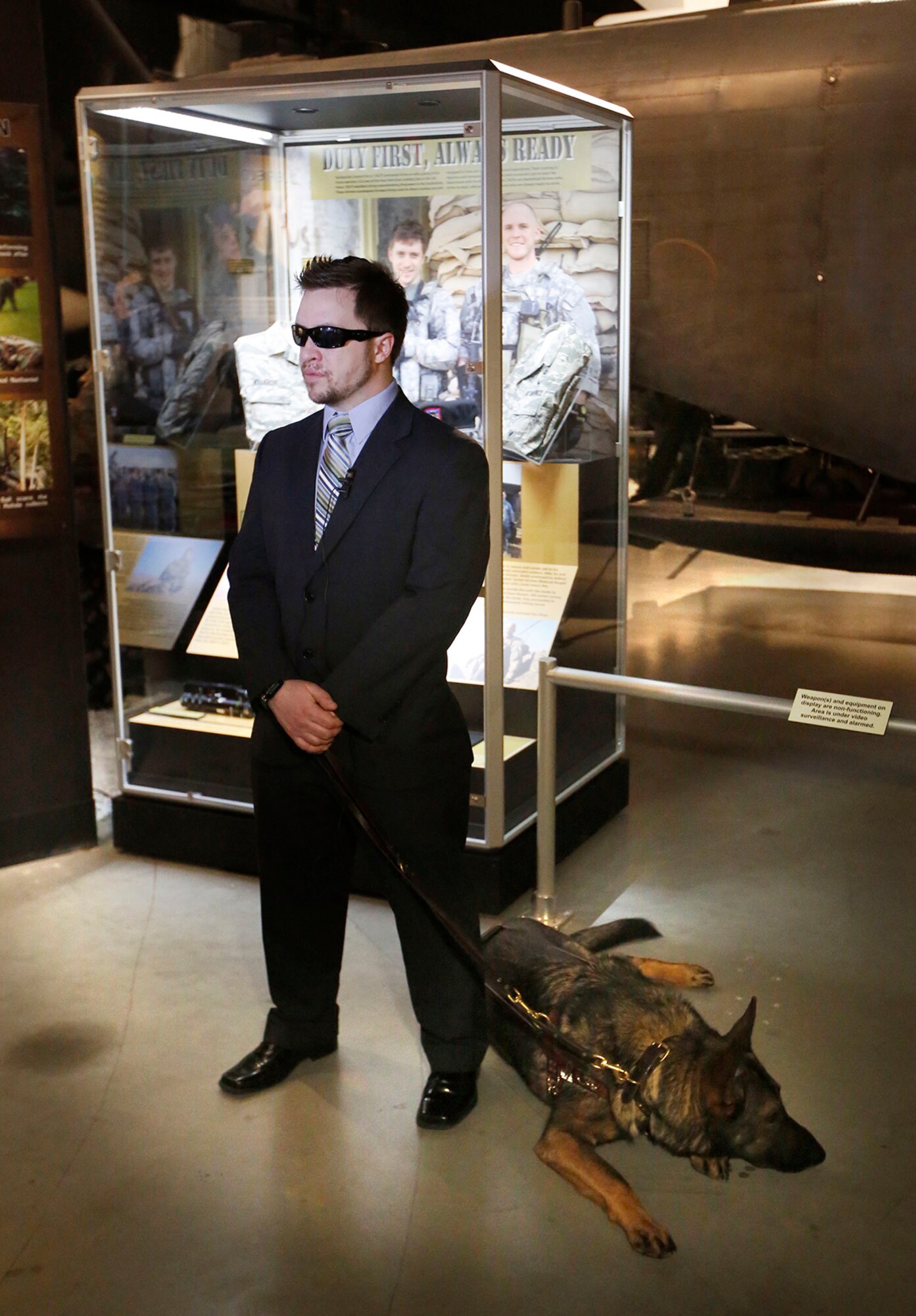 Michael Malarsie, a retired staff sergeant, and his guide dog, Xxon, attend the dedication of an exhibit featuring the story of Tactical Air Control Party personnel, including himself and Senior Airman Bradley Smith, at the National Museum of the U.S. Air Force. (Cox Media Group photo by Ty Greenlees